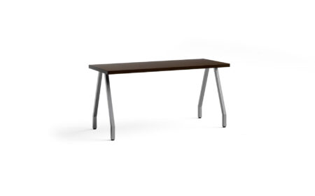 Bent angled legs stemming from a long rectangular wooden table.